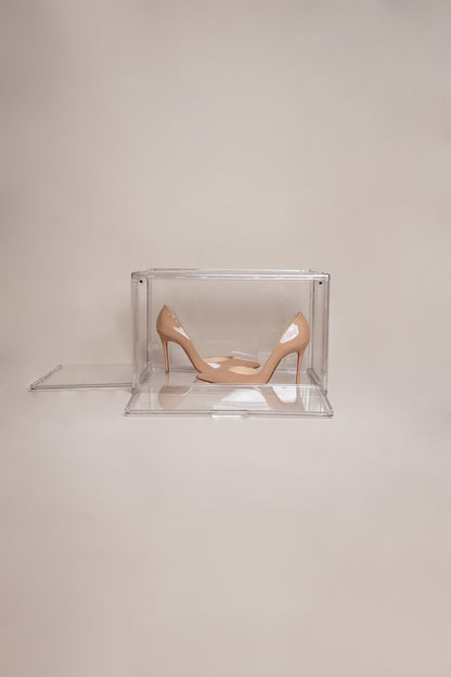 Clear shoe storage box holding a pair of nude heels